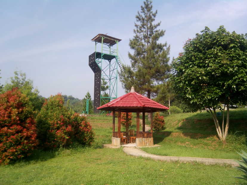Small gazebo with red roof in open grass field